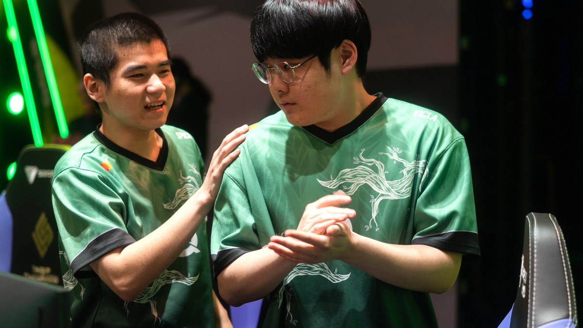 FlyQuest players Spica and Vicla talk on-stage at the Riot Games Arena after a League of Legends match.