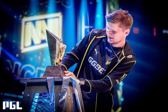 S1mple stares at a trophy after winning a CS:GO tournament.