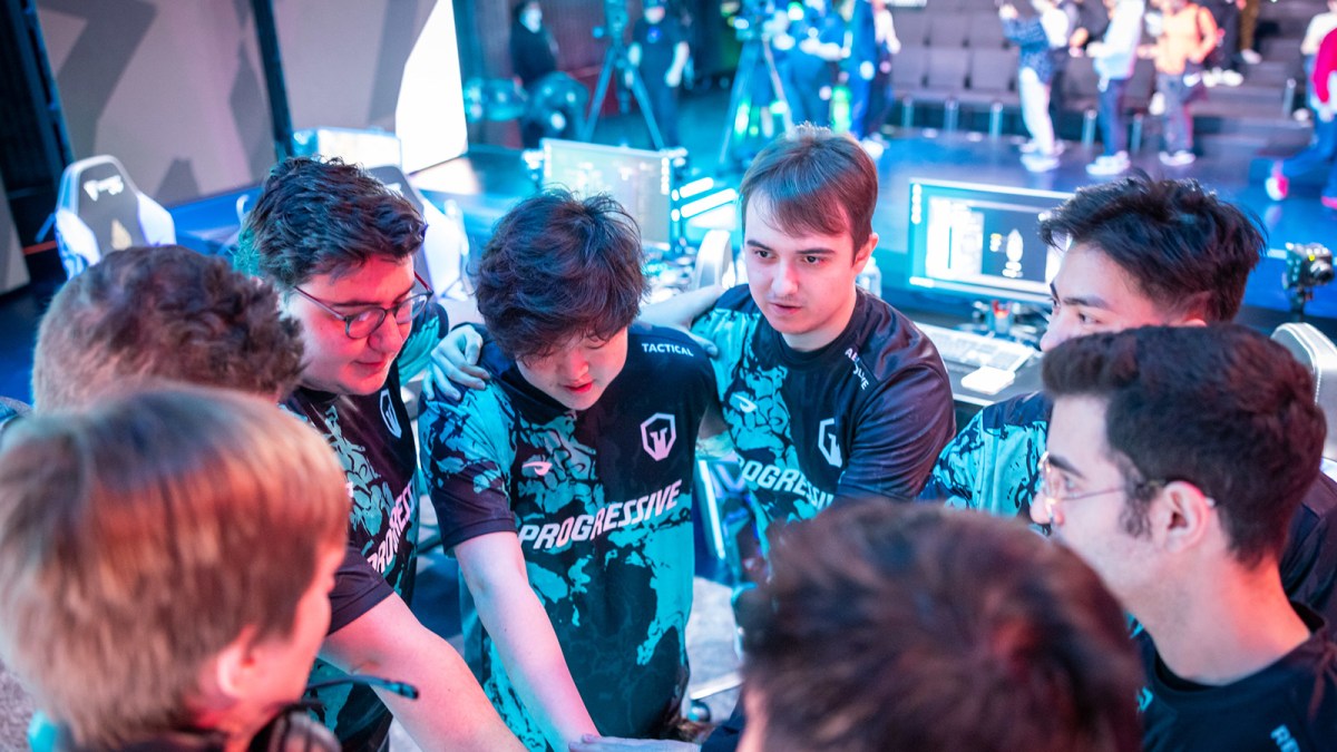 Immortals League of Legends players in a huddle at Riot Games Arena.