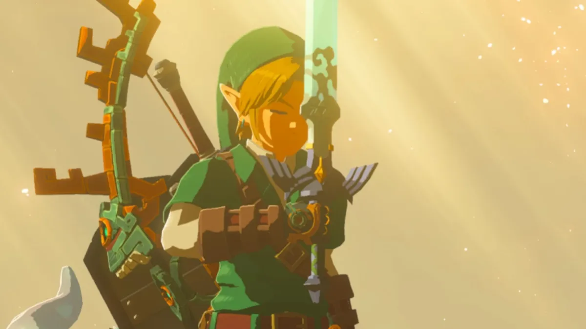 Link holding the Master Sword up to his face.