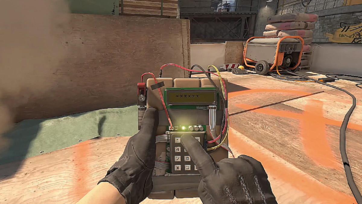 A CS2 player holds the bomb on T-side.