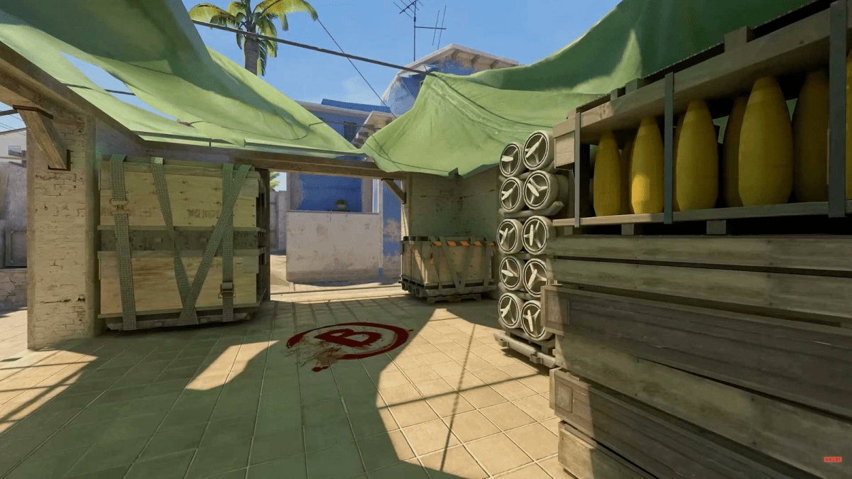 The green shadecloth and large crates that make up the B bombsite on Mirage in CS2.