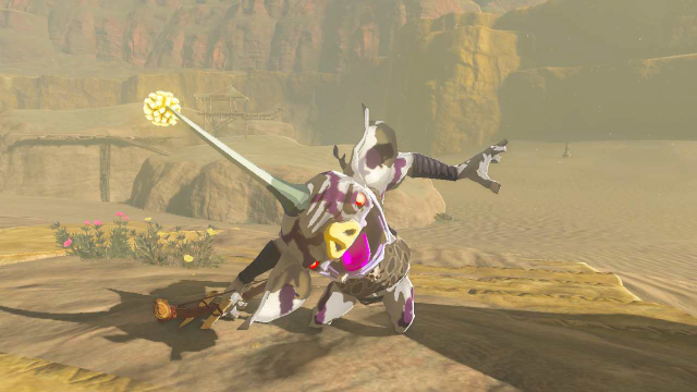 A white goblin-like creature, a Bokoblin, standing in the desert in TOTK. It's white in color with purple tribal markings, and a horn with a yellow bulb at the end, like an anglerfish. It tilts its head to the side.