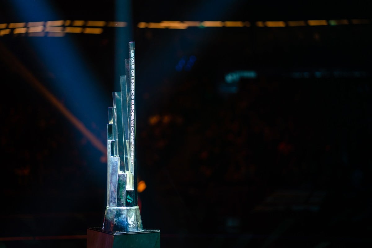The LEC trophy, a silver, spiraling crown-like trophy, dramatically lit against a dark background.