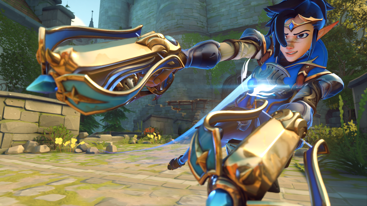 A close up of the Mythic Adventurer Tracer skin in a blue colorway, wearing a tiara and wielding crossbow pistols.