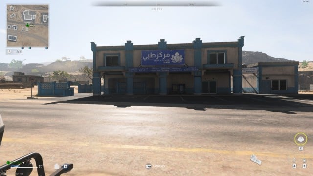 A blue-and-white medical centre surrounded by desert sands in Al Mazrah in the Warzone: DMZ game mode.