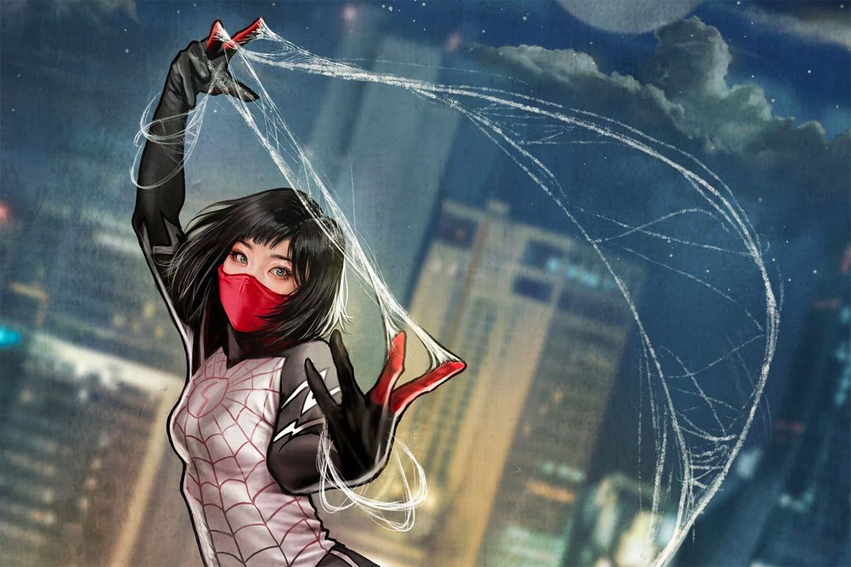 Silk weaves a web behind her, with a city in the background.