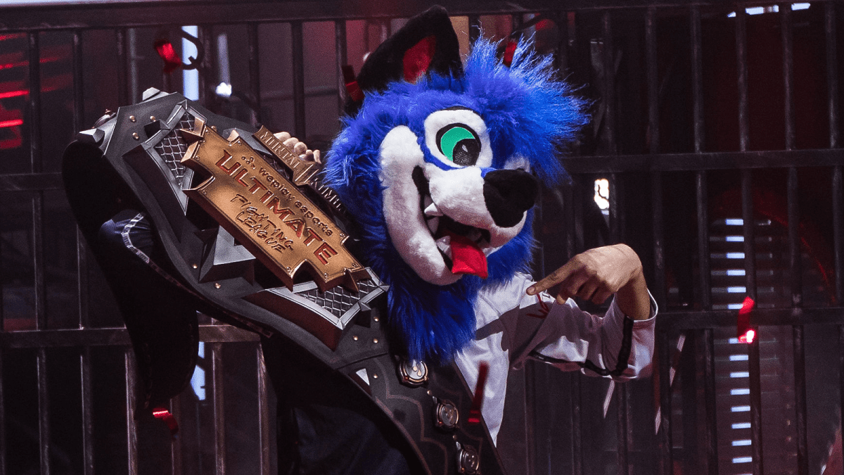 SonicFox lifting the championship belt at the Mortal Kombat WePlay Ultimate Fighting League.