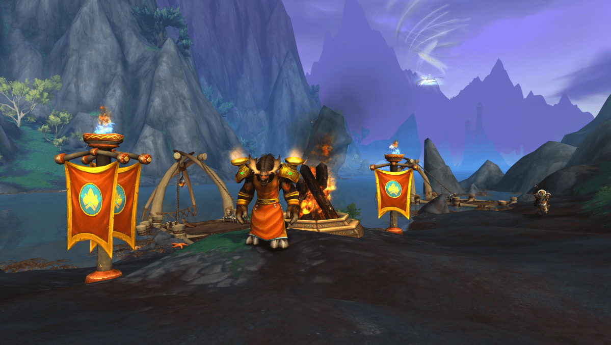 A WoW Dragonflight screenshot of a tauren in front of a bonfire during the Midsummer Fire Festival
