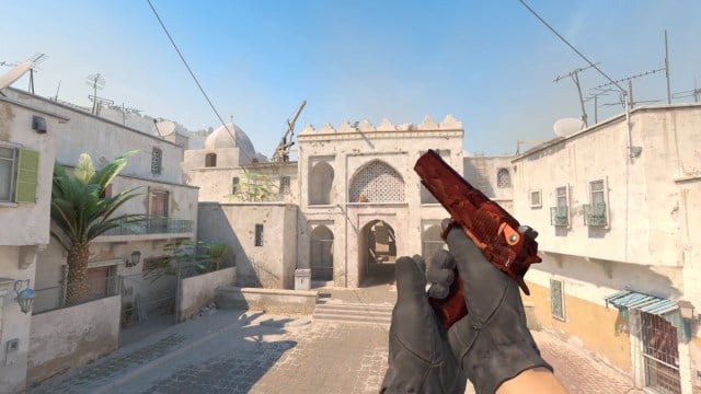 The player completes reloading of a Desert Eagle Sunset Storm outside of upper B on Dust 2 in CS2.