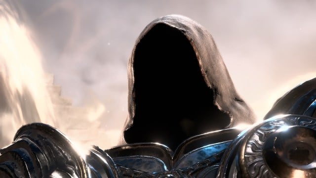 Diablo 4's Inarius stares menacingly behind his cloak in front of a bright light.