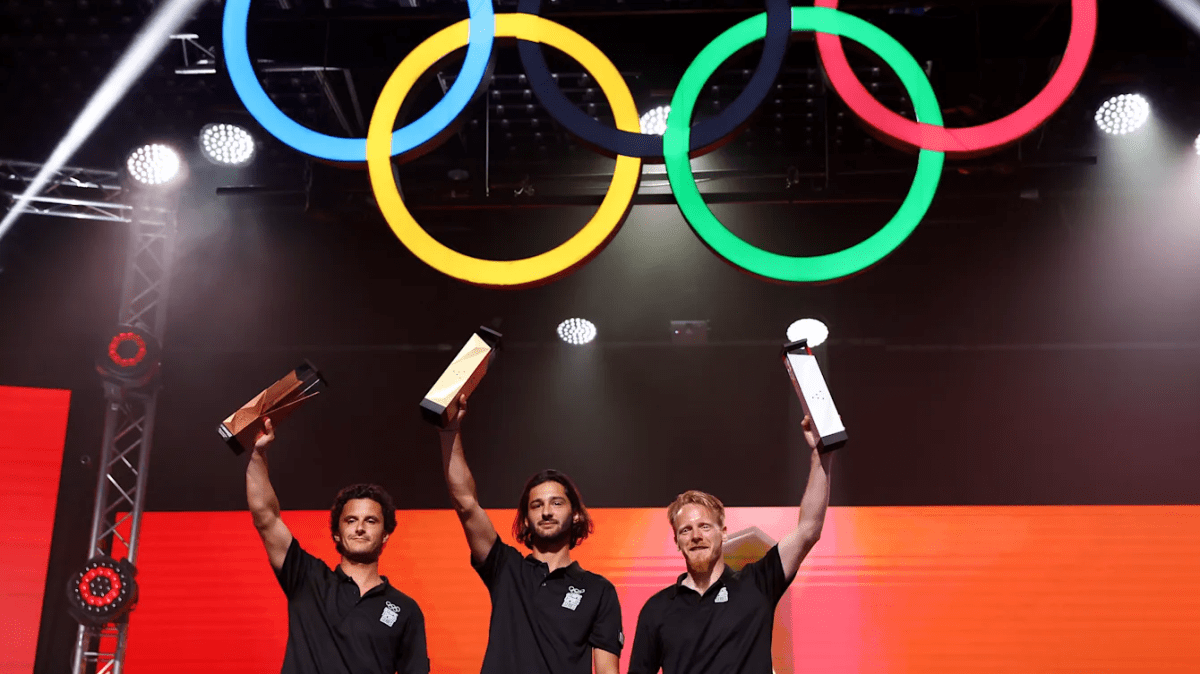 The top three competitors for Virtual Sailing lift their trophies at the Olympics Esports Week in Singapore.
