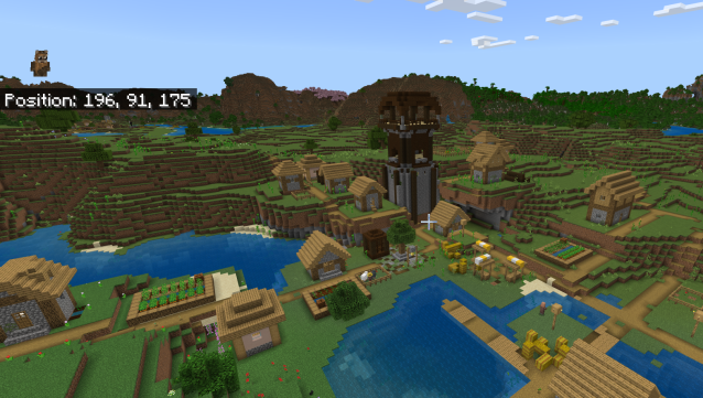 A Minecraft village with a Pillager outpost sitting in the middle of it.