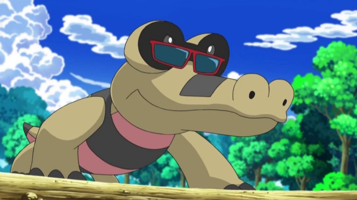 Sandile wearing sunglasses in a forest in the Pokemon anime.