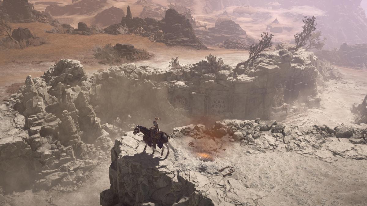 A player on horseback looks over a canyon in Diablo 4.
