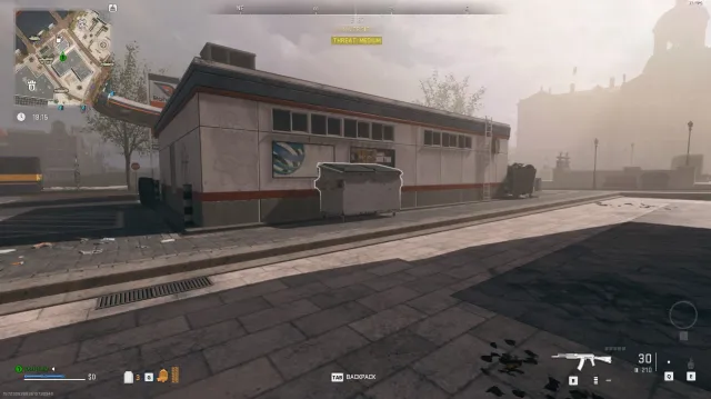 The University dead drop dumpster next to a building on the Vondel map in Warzone: DMZ.