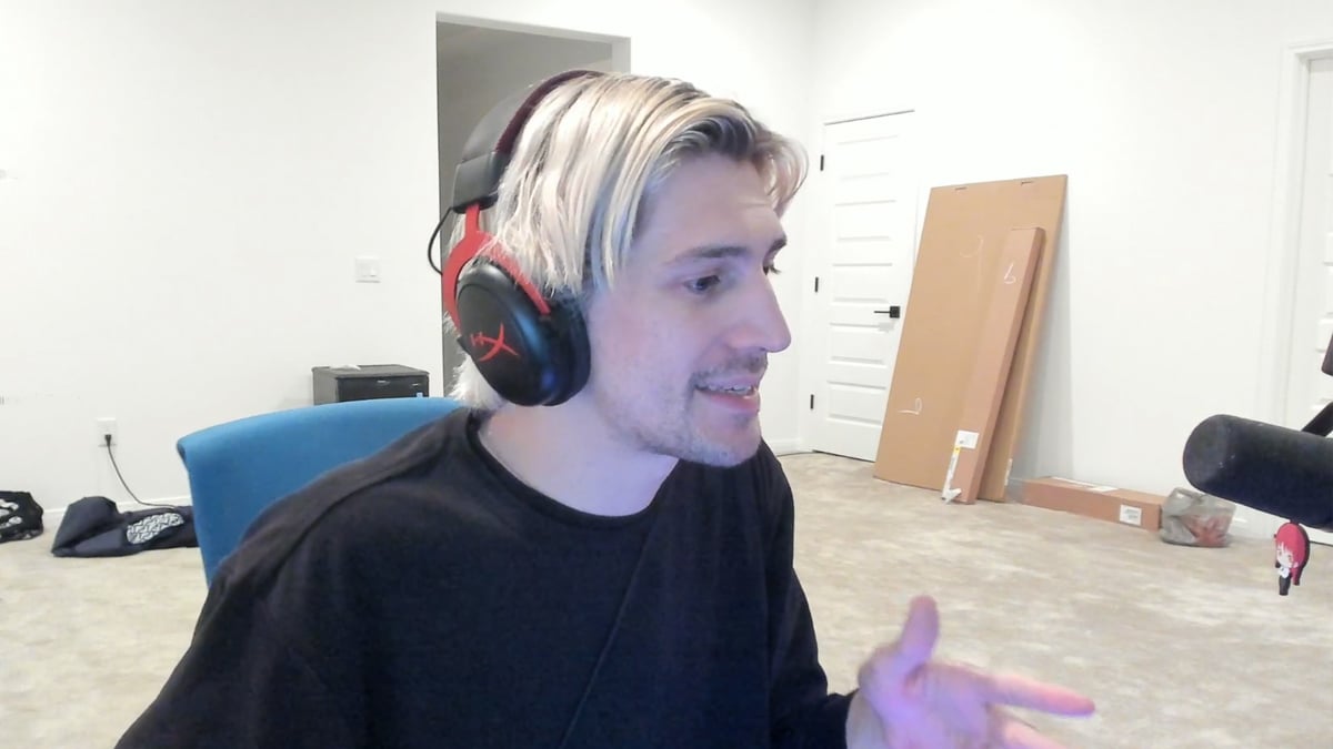 Twitch streamer xQc sits at his desk and discusses the FaZe Clan incident in his room.