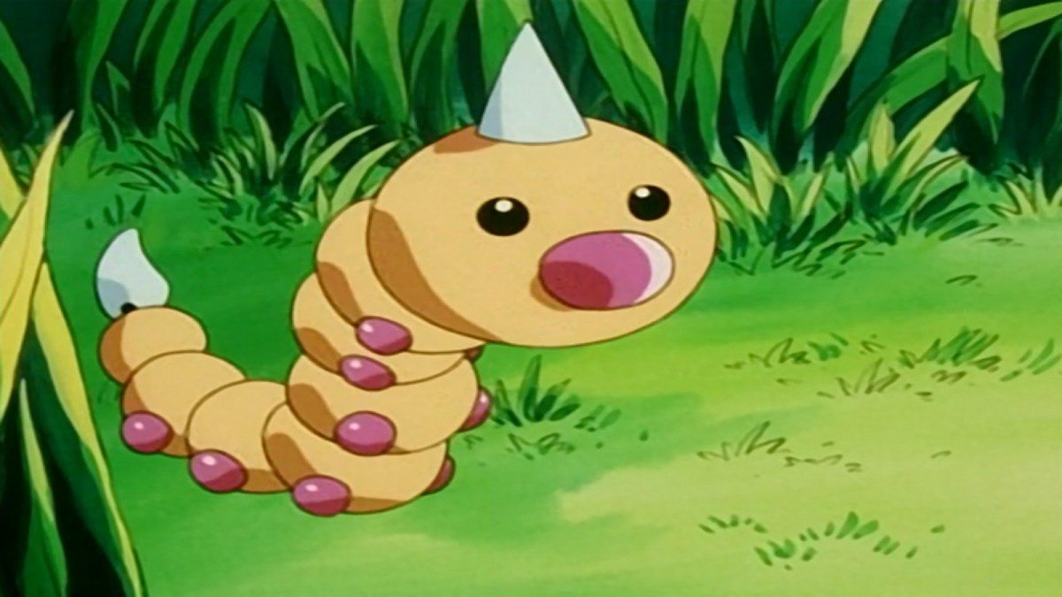 A Weedle in the Pokemon anime stands on grass in front of some plants.