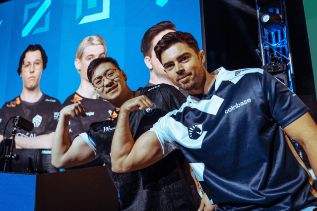 League players Midbeast and Dragku flex on-stage at the LCO finals in Melbourne.