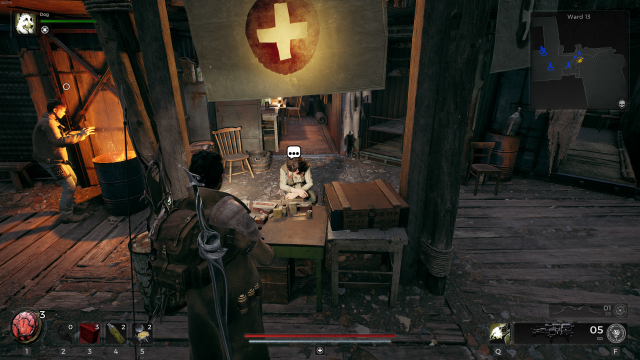 The player character in Remnant 2 stands in front of a makeshift table. A character, Dr. Norah, crouches behind the table and a dialogue bubble appears above her head. A flag with a medical cross hangs at the top of the screen.