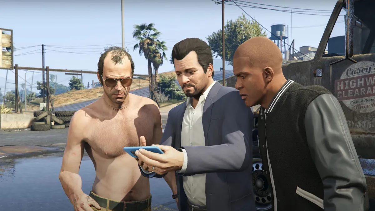 A screenshot of Michael, Trevor, and Franklin looking at a phone in GTA 5