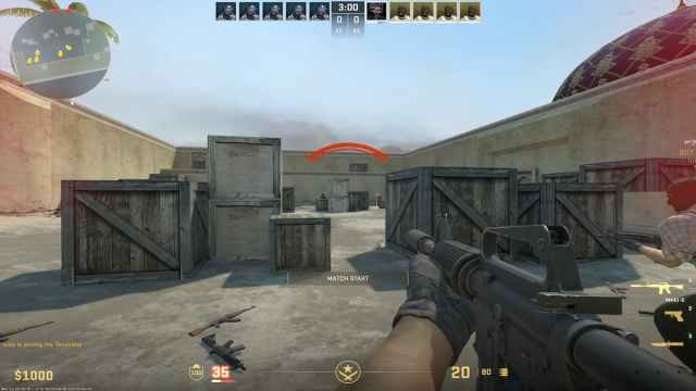 A deserted and dusty map with various boxes and weapons scattered about in CS2.