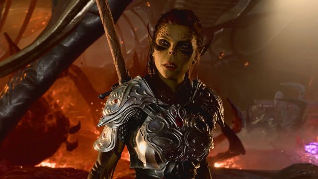 Woman with pointy ears and spots on her face wearing metal armor in Baldur's Gate 3