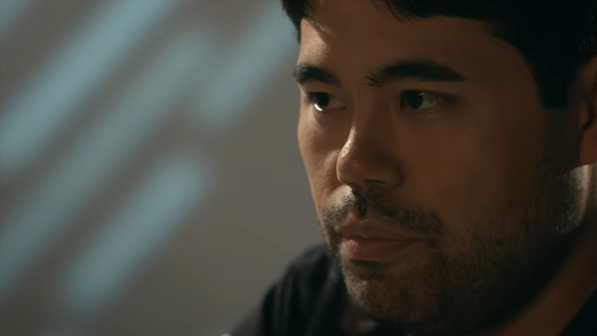 Chess GM Hikaru Nakamura stares across the board to his opponent.