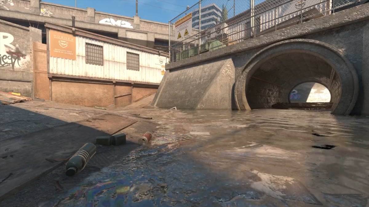 A sewer tunnel and water outside a construction hut underneath a bridge on Overpass in Counter-Strike 2.