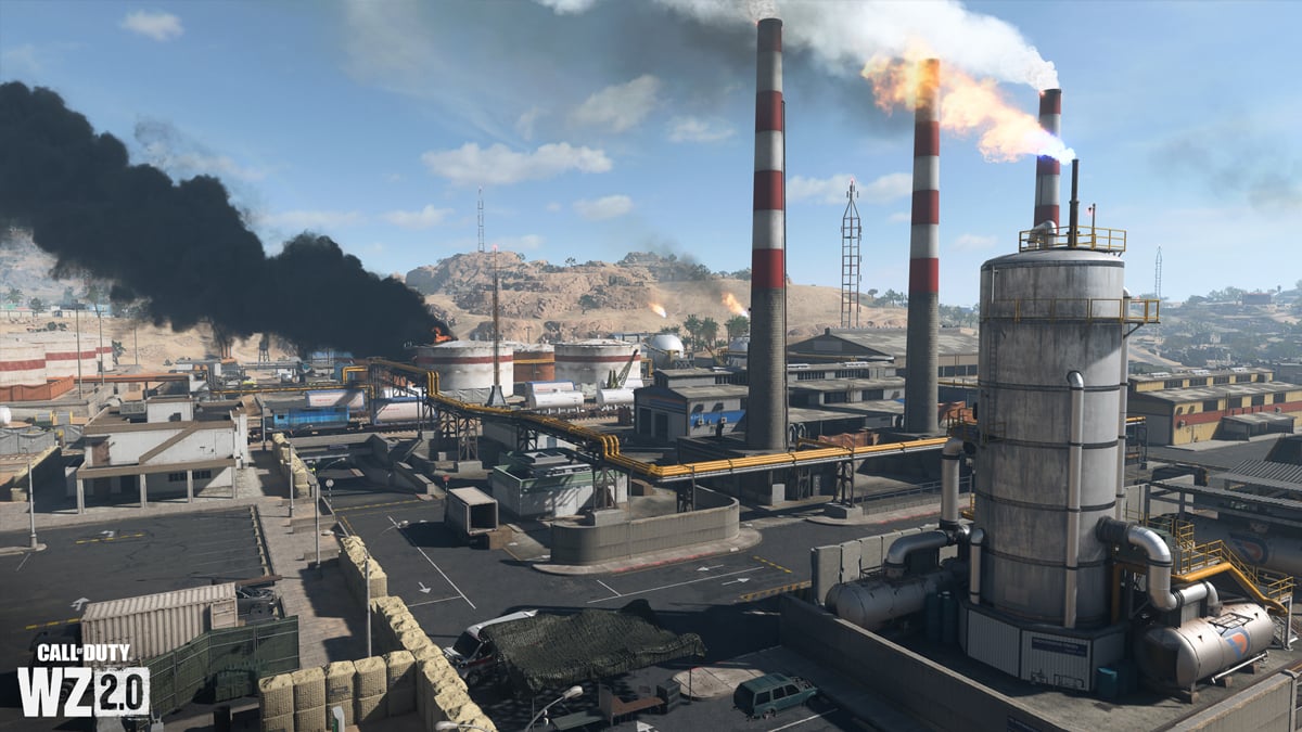 An oil refinery in the desert, with three red and white oil towers and smoke in the distance in DMZ.