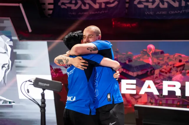 Giants Gaming VALORANT players celebrate with a hug on stage after qualifying for Champions 2023.