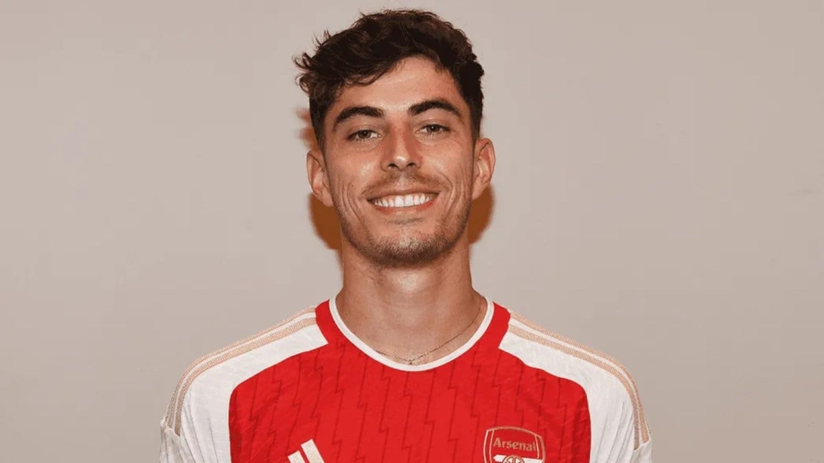 Arsenal's new signing Kai Havertz stands in front of a white background.