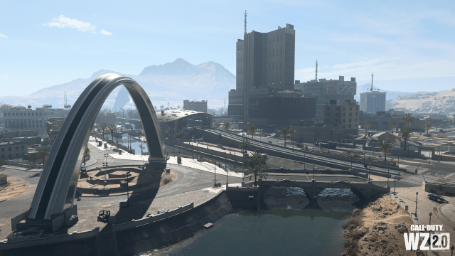 A city with a river, with an archway over a large roundabout in Al Mazrah City in DMZ.