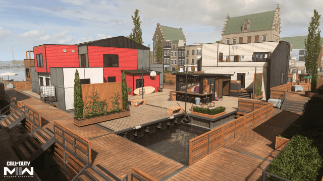 Image of the Vondel Waterfront map in MW2, which has a bright red building and an outdoor bar right on the water.