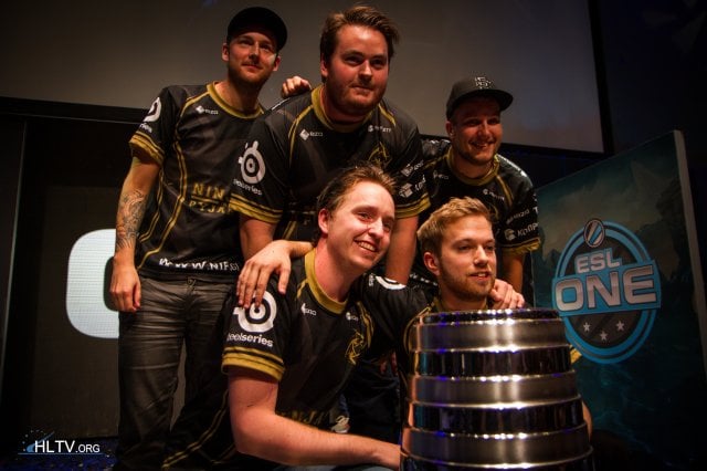 Ninjas in Pyjamas posing with the ESL One Cologne 2014 trophy in front of them.