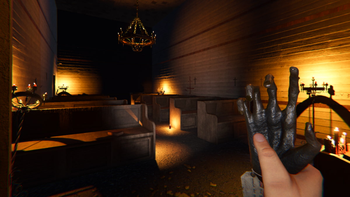 The player holding a Monkey Paw in the chapel of Sunny Meadows Mental Institution in Phasmophobia.