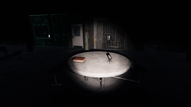 The Sound Sensor sitting on a table near a book on the Prison map. 