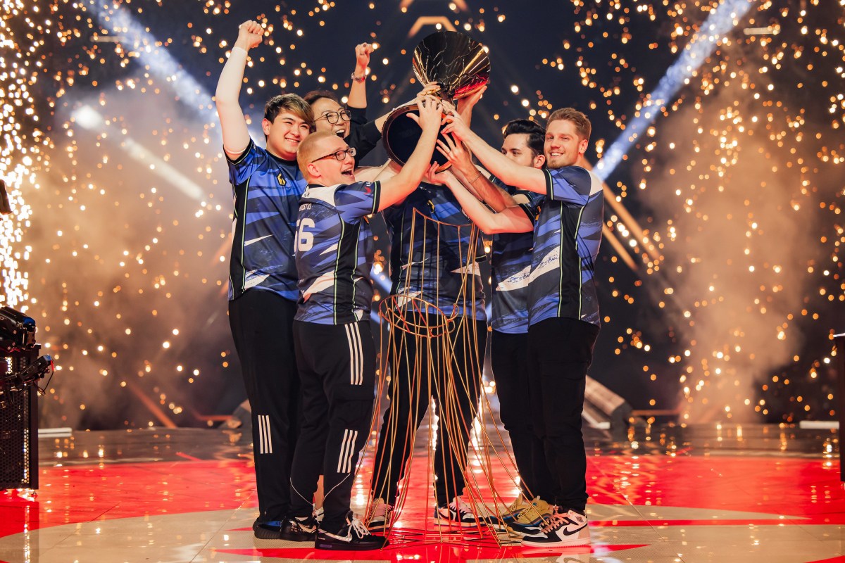 Evil Geniuses hold their VCT Champions trophy on stage in Los Angeles after their win.