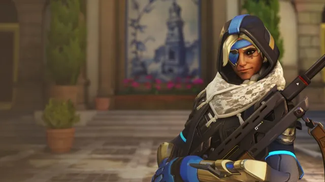 Ana, a hooded woman with an eye patch and a sniper rifle, stands looking at the camera.