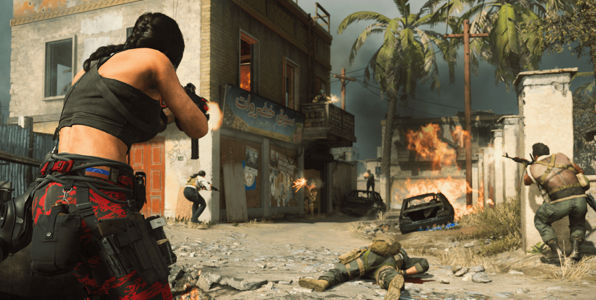 There are multiple armed soldiers firing at one another in a broken city. There are palm trees and explosions in the far background.