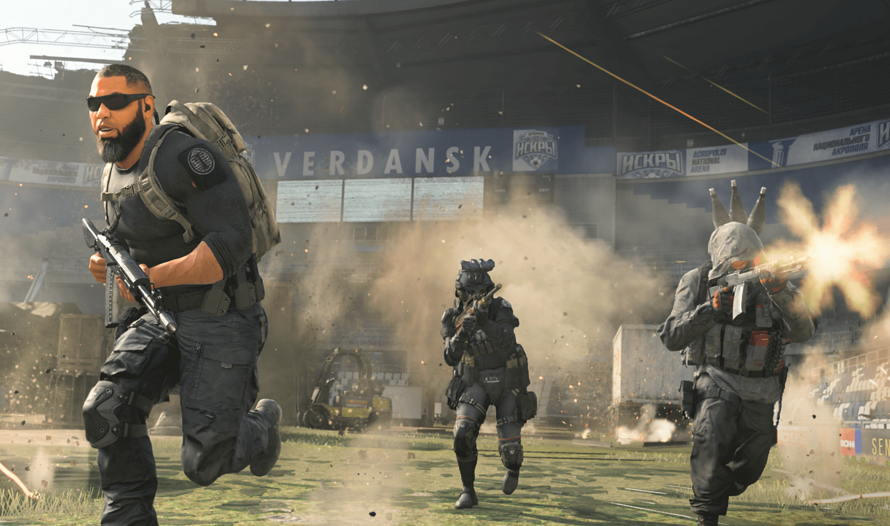 There are three armed soldiers running and firing their weapons in a stadium. There are advertisements on the banners and broken screens behind them.
