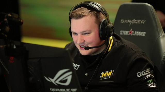 CSGO pro flamie smiles during StarLadder & i-League season 4 in 2019. He's wearing a black Natus Vincere jacket and using a black headset as well.