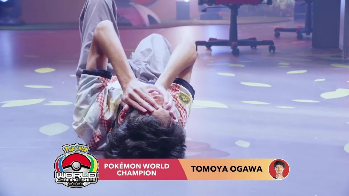 2023 Pokémon World Champion Tomoya Ogawa falls to the ground in celebration of his victory.