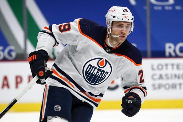Number 29 Leon Draisaitl, of Edmonton Oilers. With his mouth-guard out he is hustling back tracking the puck down.