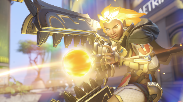 Illari from Overwatch 2 blasts of beam of golden light as her eyes and hair glow.