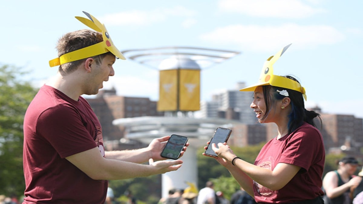 Pokémon Go players showing each other their phones at the Go Fest.