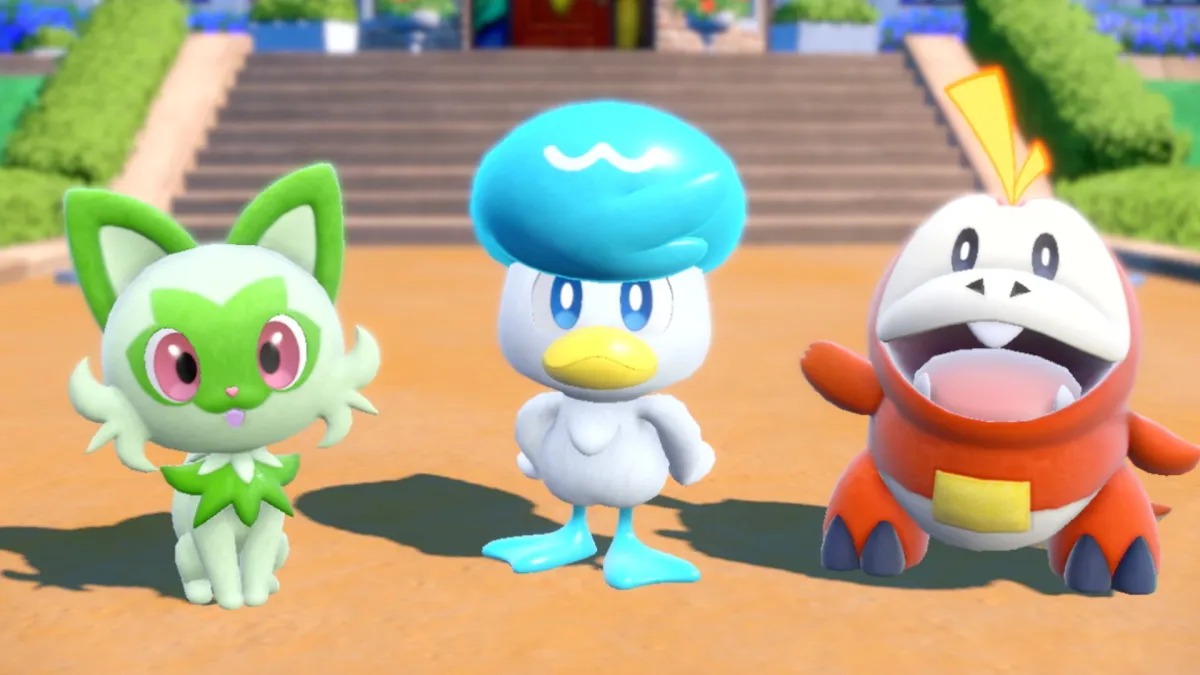 Sprigatito, Quaxly, and Fuecoco stand together in Pokémon Scarlet/Violet