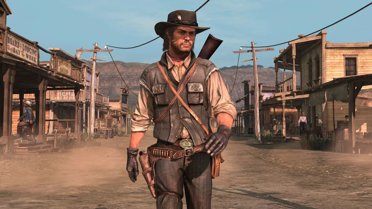 Red Dead Redemption 1's main character John Marston walks in Armadillo. He's dressed with his traditional bounty hunter outfit and his black cowboy hat.