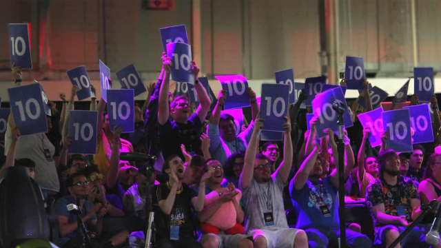 Viewers holding up signs with the number 10 at Super Smash Con.