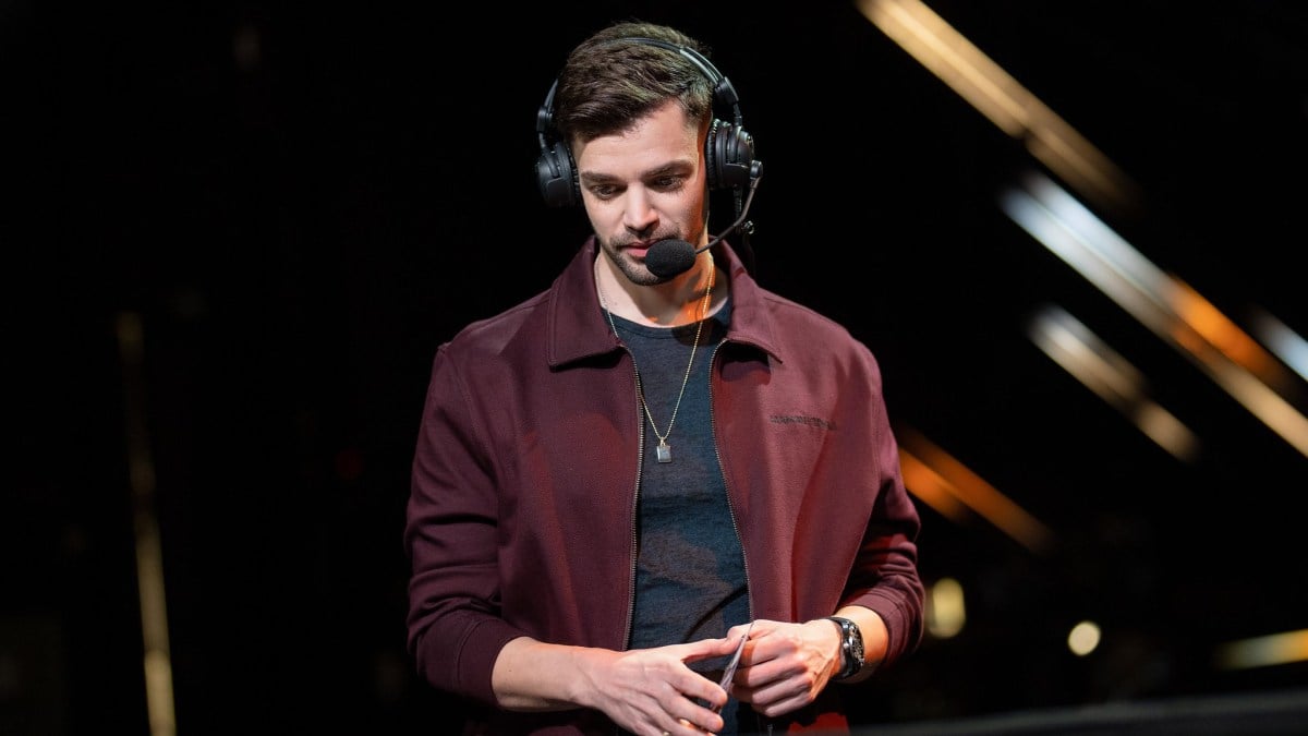 Photo of former caster turned VALORANT general manager ddk. He's a white male with short hair using a headset, staring at a monitor during a game, and is wearing a dark jarcket.
